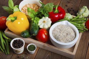 Health food with high fibre. Dietting, whole wheat cerals, grains, vegetables, antioxidants and vitamins: zzuchini, tomatoes, cucumbers, beans. Rustic wooden background top view.