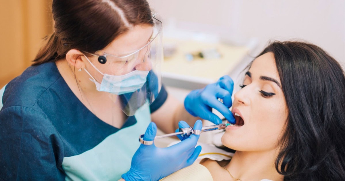 dentist administering local anaesthetic before treatment in North Lakes